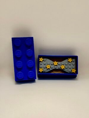 New Page Blue Lego gift box with cardboard sleeve and a sand blue Lego bow tie with small golden stars