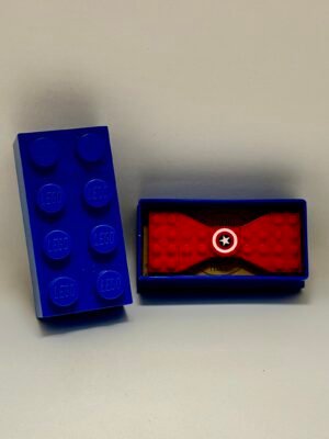 New Page Blue Lego gift box with cardboard sleeve and a red Lego bow tie with a captain America logo