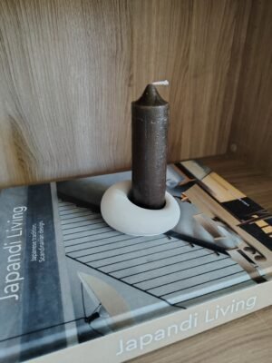 New Page Concrete candle holder with dark candle on a book