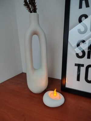 New Page Candle holder next to a vase